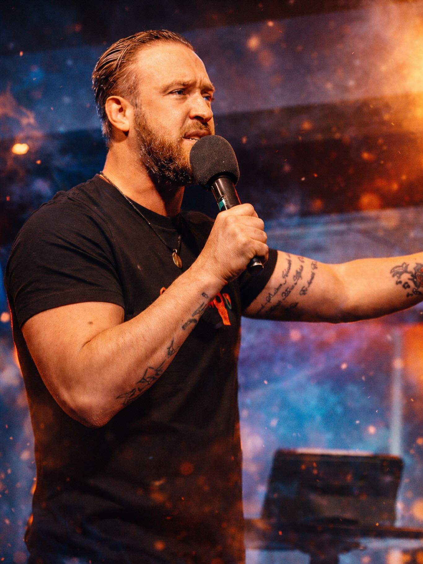Johnny Ova teaching on stage with a microphone